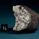 A 3.96 oz Chelyabinsk meteorite chunk next to a 1 cm cube. The broken fragment displays a thick primary fusion crust with flow lines and a heavily shocked matrix with melt veins and planar fractures.